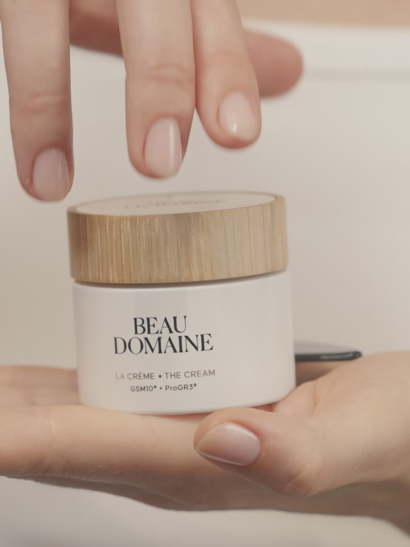 Video of a woman applying The Cream on her face and neck.
